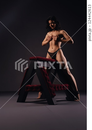 Woman Posing on A-Frame bench prepared for bdsm game Woman Posing on A-Frame bench prepared for bdsm game 124442613