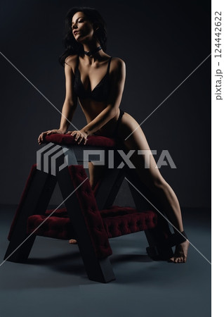 Woman Leaning on a Wooden Frame prepared for bdsm game 124442622