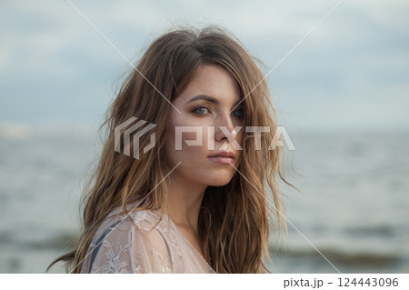 Young spring woman walking outdoors on nature background, fashion beauty portrait 124443096