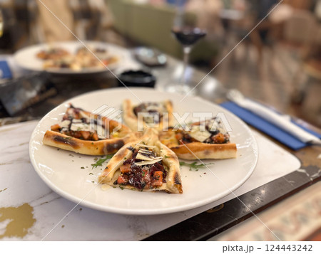 Gourmet appetizers served on a white plate in elegant restaurant setting. Fine dining, culinary aesthetics, and food presentation. 124443242