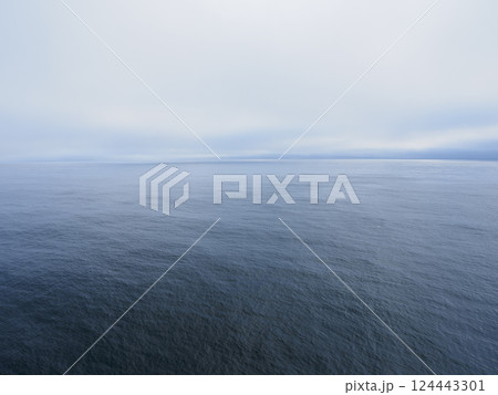 Overcast sky above calm sea 124443301