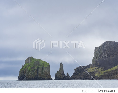 Storm clouds above rocky island and sea Storm clouds above rocky island and sea 124443304