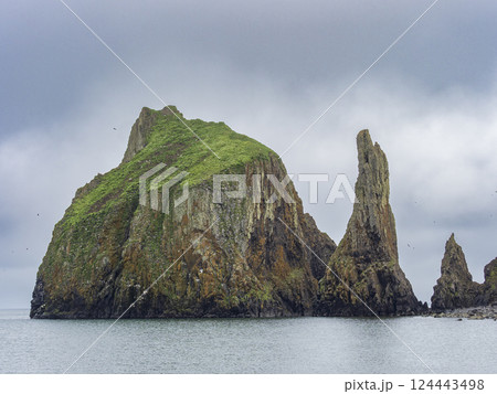 Storm clouds above rocky island and sea 124443498