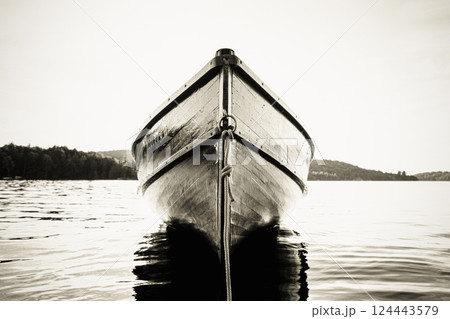 Wood boat anchored on Upper Saranac Lake, black and white 124443579