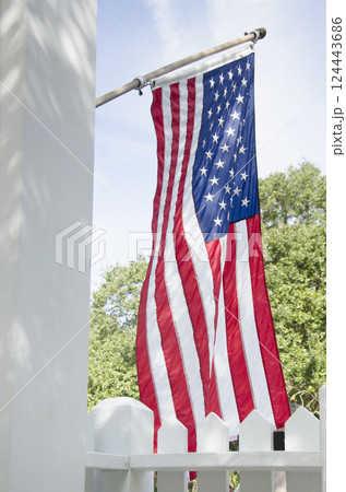 American flag hanging from front porch American flag hanging from front porch 124443686