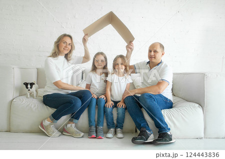 Happy family at home. Housing, relocation, real estate and insurance concept Happy family at home. Housing, relocation, real estate and insurance concept 124443836