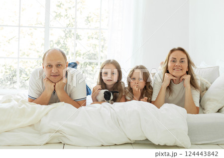 Portrait of family relaxing on the couch together at home 124443842