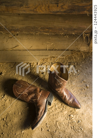 Overhead view of pair of leather cowboy boots in stable Overhead view of pair of leather cowboy boots in stable 124443925