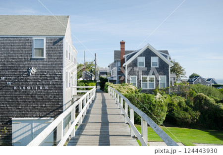 Footbridge and coastal houses on sunny day Footbridge and coastal houses on sunny day 124443930