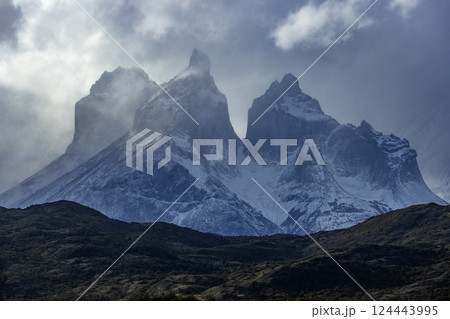Clouds over snow covered peaks of Torres Del Paine 124443995
