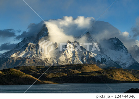 Clouds over snow covered peaks of Torres Del Paine and Pehoe Lake 124444046