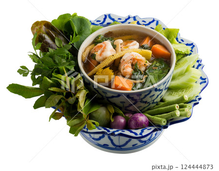Spicy vegetable and prawn soup isolated on a white background. Spicy vegetable and prawn soup isolated on a white background. 124444873