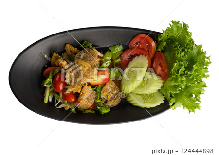 Thai cuisine spicy salad with Fried Trichogaster pectoralis slice fry for crispy isolated on a white background. Thai cuisine spicy salad with Fried Trichogaster pectoralis slice fry for crispy isolated on a white background. 124444898