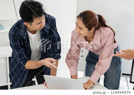 Collaboration and Teamwork. Professionals discussing project ideas over a laptop. 124444974
