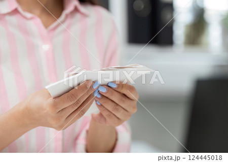 Managing Finances and Home Office Stress. A woman meticulously reviewing receipts in her organized workspace. Managing Finances and Home Office Stress. A woman meticulously reviewing receipts in her organized workspace. 124445018