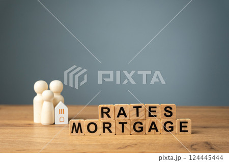 Loan and credit interest. Apartments, housing and house. Real estate market analysis concept. Business and finance. Wooden blocks with the words Rates mortgage and family with house. 124445444