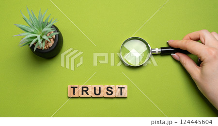 Wooden blocks with the word Trust. Trust relationships between business partners, friends, relatives. Respect and authority. Confidence in a person. Reliable partner Wooden blocks with the word Trust. Trust relationships between business partners, friends, relatives. Respect and authority. Confidence in a person. Reliable partner 124445604