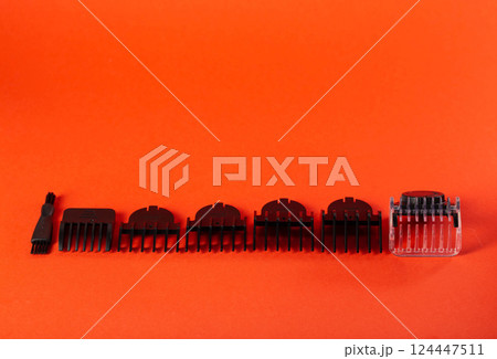 Set of edging attachments for trimmer on a red background, close-up. Copy space for text Set of edging attachments for trimmer on a red background, close-up. Copy space for text 124447511