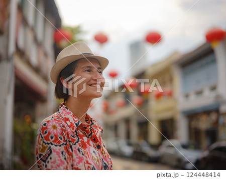 woman exploring streets of George Town, during Chinese New Year. 124448414
