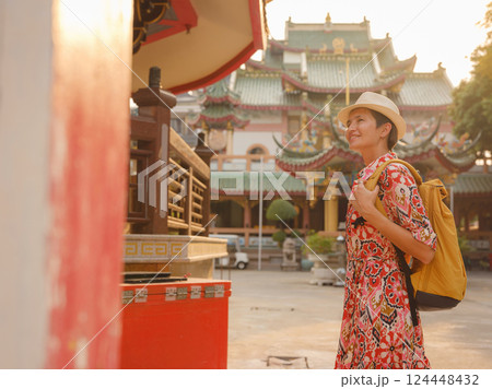 Woman Exploring Colorful Streets Near Buddhist Temples in Bangkok Woman Exploring Colorful Streets Near Buddhist Temples in Bangkok 124448432