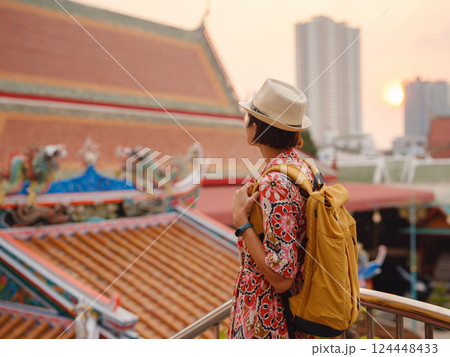 Woman Exploring Colorful Streets Near Buddhist Temples in Bangkok Woman Exploring Colorful Streets Near Buddhist Temples in Bangkok 124448433