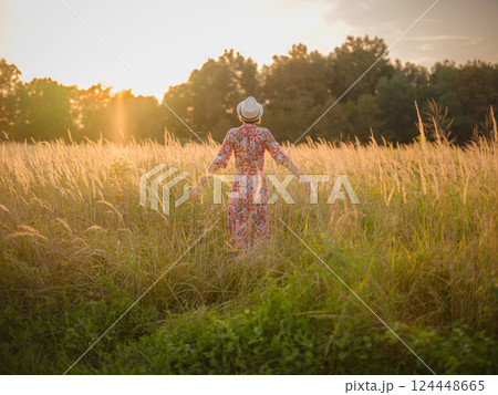 boho chic woman in a floral dress in European countryside 124448665