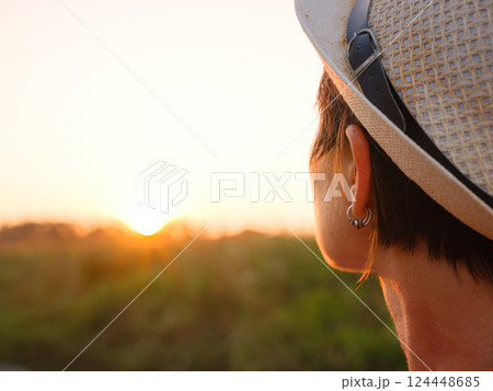 Warm sunset hues create peaceful, dreamy countryside atmosphere. 124448685