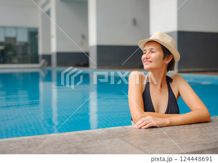 Young woman relaxing by the pool at a Kuala Lumpur hotel 124448691