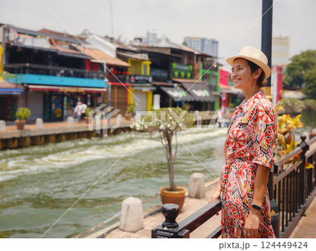 woman in dress and hat exploring vibrant streets of Malacca, Malaysia. woman in dress and hat exploring vibrant streets of Malacca, Malaysia. 124449424