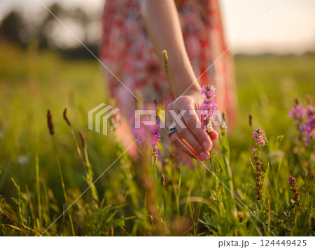 boho chic woman in a floral dress in European countryside boho chic woman in a floral dress in European countryside 124449425