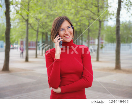 Woman in glasses stands in center of Frankfurt, 124449465