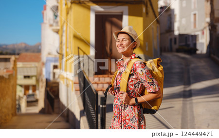 Woman strolls through colorful streets of Spanish coastal town Woman strolls through colorful streets of Spanish coastal town 124449471