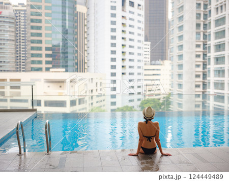 Young woman relaxing by the pool at a Kuala Lumpur hotel 124449489