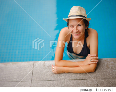 Young woman relaxing by the pool at a Kuala Lumpur hotel 124449491