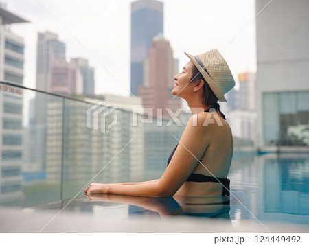 Young woman relaxing by the pool at a Kuala Lumpur hotel 124449492