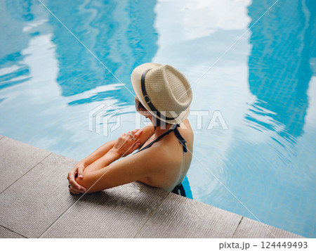 Young woman relaxing by the pool at a Kuala Lumpur hotel 124449493