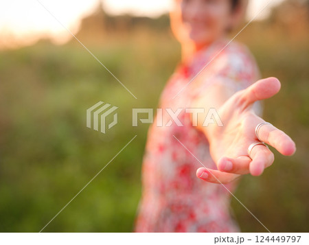 Warm sunset hues create peaceful, dreamy countryside atmosphere. 124449797