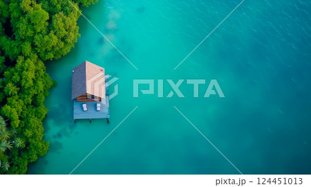 A small house on a small island in the middle of a body of water 124451013