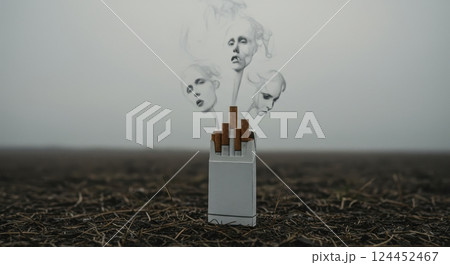 Cigarette pack with smoke forming ghostly faces, symbolizing the dangers and health risks of smoking and tobacco addiction. 124452467