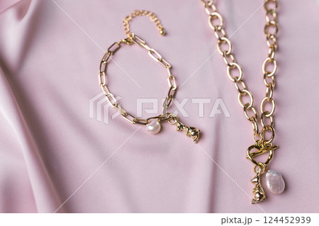Women's Jewelry. Trendy jewelry on silk background. Flat lay, top view. Women's Jewelry. Trendy jewelry on silk background. Flat lay, top view. 124452939