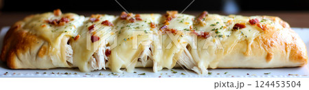 Close-up of a freshly baked chicken bacon ranch stromboli, featuring golden-brown crust, melted cheese, and savory filling Close-up of a freshly baked chicken bacon ranch stromboli, featuring golden-brown crust, melted cheese, and savory filling 124453504