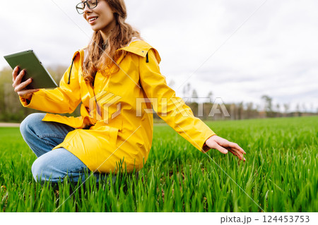 Innovative smart farm system technology, agricultural management. Farmer with tablet in green field Innovative smart farm system technology, agricultural management. Farmer with tablet in green field 124453753
