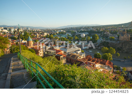 Sunny landscape of old Tbilisi and green mountains on the background 124454825