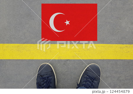 Word Start on an asphalt road with the Turkish flag  and legs in shoes. Immigration 124454879