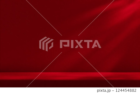 Red studio room wall, illuminated by sunlight through foliage with tabletop. Product presentation template. 124454882