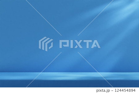 Blue studio room wall, illuminated by sunlight through foliage with tabletop. Product presentation template. 124454894