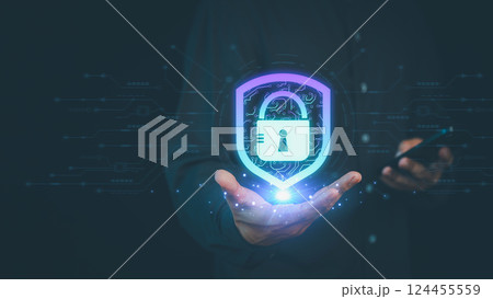 Business person holds a glowing digital shield with a lock symbol, representing cybersecurity, data protection, privacy, and secure technology against online threats. Business person holds a glowing digital shield with a lock symbol, representing cybersecurity, data protection, privacy, and secure technology against online threats. 124455559