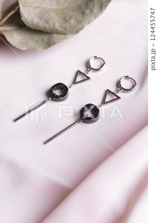 Elegant jewelry set of silver earrings with gem. Jewelry set minimalist style. Handmade bijouterie concept. Elegant jewelry set of silver earrings with gem. Jewelry set minimalist style. Handmade bijouterie concept. 124455747