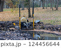 Dredger for cleaning reservoirs in the autumn park. Method of cleaning a reservoir. Preparing the park for the tourist season. Working platform for cleaning river beds and reservoir bottoms. 124456644