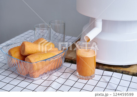Juicer close-up. carrots are next to each other in a glass container. Copy space. Juicer close-up. carrots are next to each other in a glass container. Copy space. 124459599